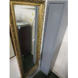 A long rectangular bevelled edge wall mirror in a moulded gilt frame