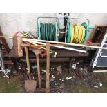 TWO HOSES ON REELS TOGETHER WITH A PUMP SPRAY AND OTHER ASSORTED GARDENING ITEMS.
