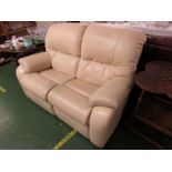 BEIGE LEATHER EFFECT MANUAL RECLINING TWO-SEATER SOFA.