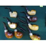 Eight vintage Peterson tobacco pipes (including some meerschaum) with sterling silver collars.