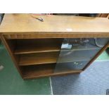 OAK BOOK CASE WITH SLIDING GLASS DOORS.