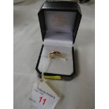 18 carat gold ring set with three red stones and two very small white stones, British hallmarks,