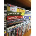 ONE SHELF OF CDS INCLUDING JAZZ , COUNTRY AND EASY LISTENING.