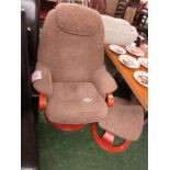 PALE BROWN UPHOLSTERED SWIVEL CHAIR AND MATCHING FOOT STOOL