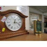 A wooden mounted quartz mantle clock, and a Swiza vintage cylindrical clock alarm clock