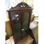 MAHOGANY WALL MOUNTING CABINET WITH TWO GLAZED DOORS AND TWO INTERNAL SHELVES.