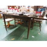 MID WOOD EXTENDING DINING TABLE TOGETHER WITH FOUR STICK BACK CHAIRS.
