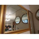 Rectangular bevelled wall mirror in gilt effect frame.