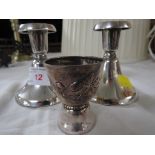 Pair of filled white metal candle sticks stamped 830S, together with white metal egg cup stamped