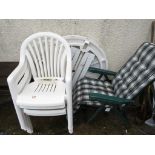 WHITE PLASTIC CIRCULAR GARDEN TABLE WITH FOUR CHAIRS TOGETHER WITH A GREEN FOLDING LOUNGER WITH