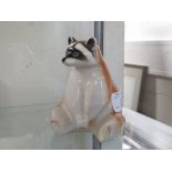 CERAMIC FIGURE OF A SEATED RACOON MARKED MADE IN THE USSR.