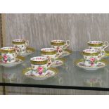 SEVEN COPELAND SPODE HARRODS LIMITED COFFEE CUPS AND SAUCERS DECORATED WITH FLOWERS.