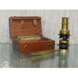 MINIATURE BRASS MICROSCOPE WITH A FITTED MAHOGANY CASE.