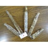 SIX ASSORTED VICTORIAN PENCIL-SLIM CUT GLASS GILDED AND ENAMELLED SCENT BOTTLES, TWO MEASURING 17CMS