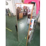 LONG RECTANGULAR WALL MIRROR WITH LIGHT WOOD MOUNTING.