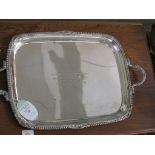 AN OBLONG TWO-HANDLED SILVER TRAY WITH GADROONED EDGE AND FOLIATE MOULDING, WITH PRESENTATION