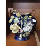 BLUE GLAZED MAJOLICA STYLE VASE ENCRUSTED WITH ROSE BRANCH.