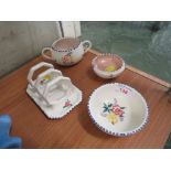 FOUR PIECES OF POOLE POTTERY INCLUDING A TOAST RACK.