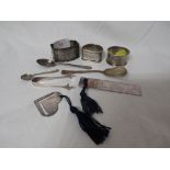 SELECTION OF SILVER ITEMS INCLUDING SPOONS, BOOKMARKS, AND NAPKIN RINGS.