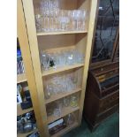 FIVE SHELVES OF GLASSWARE INCLUDING STEMMED DRINKING GLASSES, MUGS, VASES AND OTHER ITEMS.