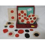 SELECTION OF ANTIQUE FOB SEAL IMPRESSIONS IN A LEATHER CLAD BOX.