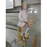 LARGE CONTINENTAL PORCELAIN FIGURINE OF A MAN WITH BASKET AND FRUIT.