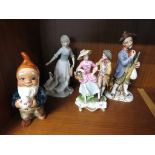 FOUR CERAMIC AND PORCELAIN FIGURINES INCLUDING FIGURAL GROUP AND LLADRO STYLE GIRL WITH DUCKS.
