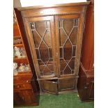 LEADED AND GLAZED OAK TWO-DOOR BOOKCASE WITH TWO DOORS TO BASE. (AF)