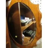 OVAL BEVELLED EDGED MIRROR IN A LAMINATED WOODEN FRAME.