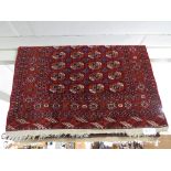 RED GROUND RECTANGULAR PATTERN MIDDLE EASTERN CARPET WITH SEVEN MARGINS.