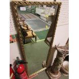 LONG RECTANGULAR WALL MIRROR IN A GILT EFFECT FRAME.