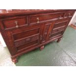 OAK SIDEBOARD WITH THREE DRAWERS AND TWO CUPBOARD DOORS AND HEAVY BRASS HANDLES.