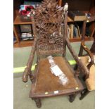 EXTENSIVELY CARVED 19TH CENTURY MAHOGANY ARMCHAIR WITH A CARVED AND PIERCED BACK DEPICTING VARIOUS
