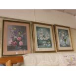 THREE FRAMED AND GLAZED STILL LIFE COLOURED PRINTS OF FLOWERS IN VASES.