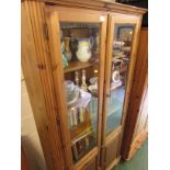 DUCAL HONEY PINE GLAZED BOOK CASE WITH THREE INTERNAL SHELVES AND TWO CUPBOARD DOORS TO ITS BASE.
