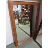 RECTANGULAR BEVEL EDGED WALL MIRROR IN A MID WOOD FRAME