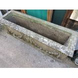 SUBSTANTIAL COMPOSITE STONE OBLONG TROUGH DECORATED WITH GARLAND AND ROUNDEL