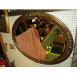 OVAL BEVELLED EDGE MIRROR IN A GILT EFFECT FRAME.