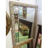 RECTANGULAR BEVEL EDGED MIRROR IN A FOLIATE EFFECT FRAME.