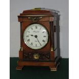 A REPRODUCTION MANTEL CLOCK.