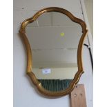 CARTOUCHE SHAPE MIRROR IN A GILT EFFECT FRAME.