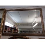 RECTANGULAR BEVELLED EDGE WALL MIRROR IN A BURNISHED EFFECT FRAME.