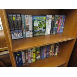 TWO SHELVES OF VIDEO TAPES INCLUDING DISNEY TITLES.