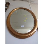 OVAL BEVEL EDGE MIRROR IN A GILT FRAME.