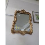 RECTANGULAR WALL MIRROR IN A MOULDED GILT FRAME.