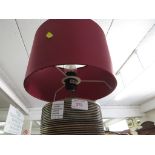 WOODEN BODIED TABLE LAMP WITH RED SHADE.