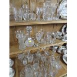 THREE SHELVES OF MIXED GLASS WARE INCLUDING STEM DRINKING GLASSES , VASES , BOWLS , CAKE STAND ETC.