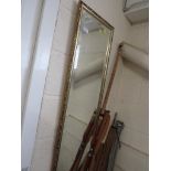 LONG RECTANGULAR BEVEL EDGE MIRROR IN A GILT EFFECT FRAME.