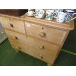 STRIPPED PINE CHEST OF TWO SHORT OVER TWO LONG DRAWERS STANDING ON TURNED FEET. (AF)