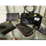 FOUR BLACKBERRY SMART PHONES WITH ACCESSORIES AND CHARGERS.